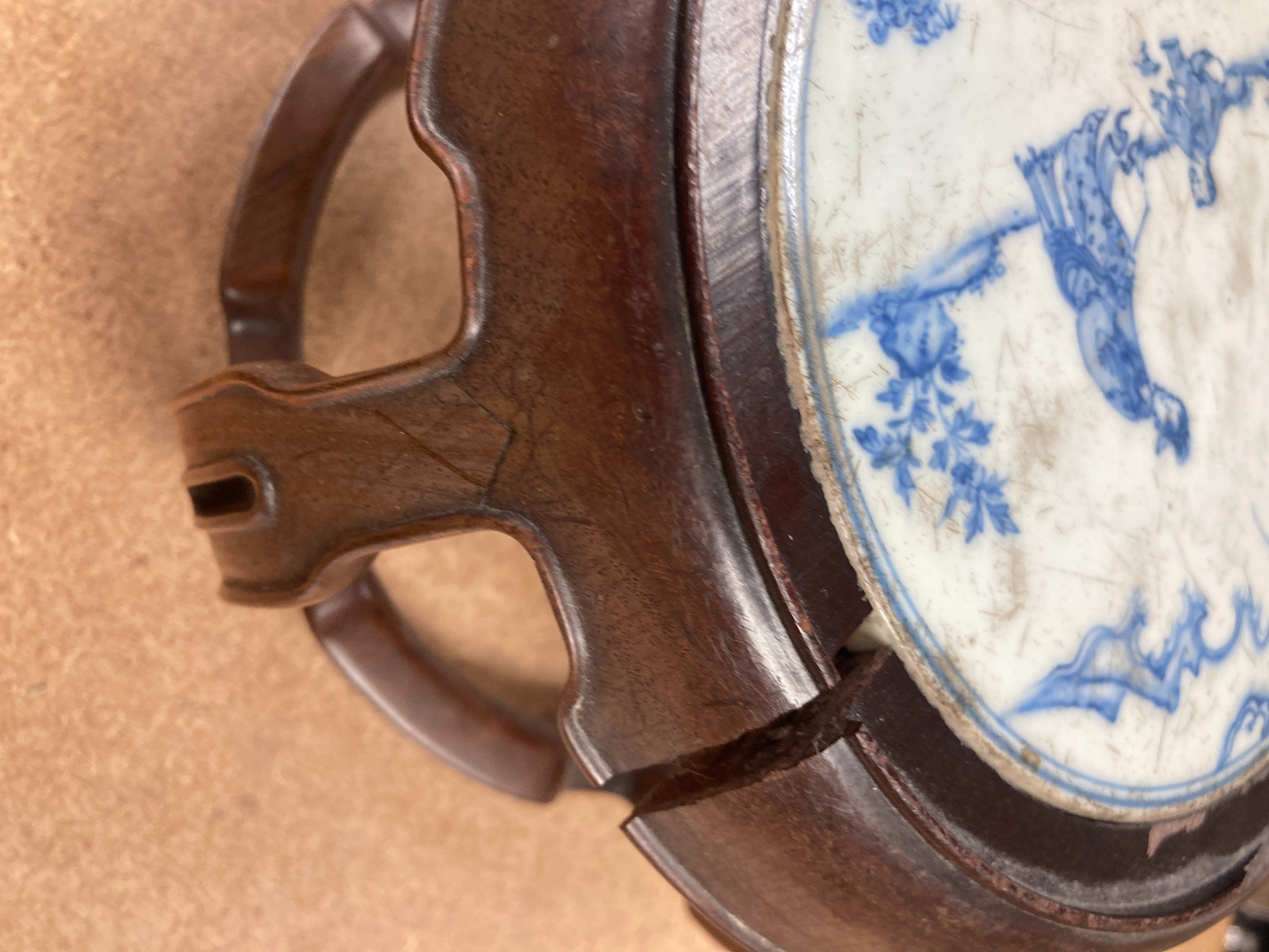 A 19th century Chinese blue and white circular tile inset hongmu stand, 22cm